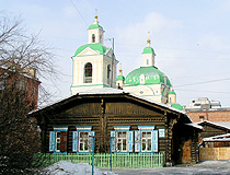 Old wooden house and the Annunciation Church in Krasnoyarsk